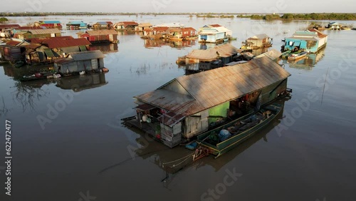 House on river with a dog, 4k Drone footage of a floating village during sunset, Kampong Phluk, Cambodia, Boats, fisherman