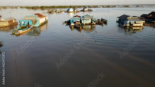 Houses on water, 4k Drone footage of a floating village during sunset, Kampong Phluk, Cambodia, Boats, fisherman