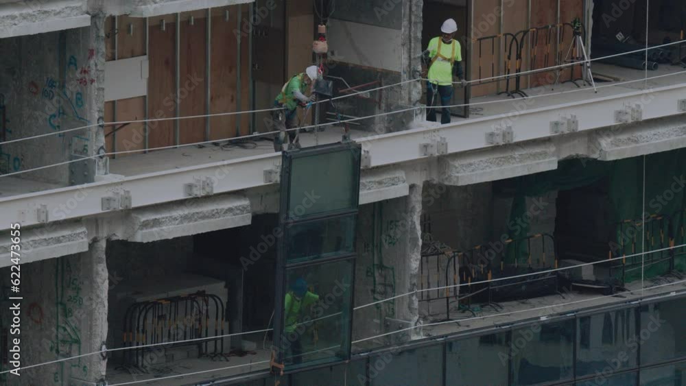 Glazing Of A Building Under Construction In Hong Kong, Asia Glazing Of A Building Under Construction In Hong Kong, Asia