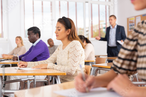 Bilde på lerret Portrait of attentive focused hispanic woman on lesson in school auditorium