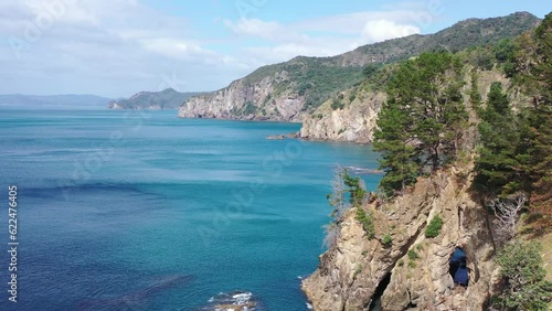 New Zealand Coast rising aerial view with hole in rock