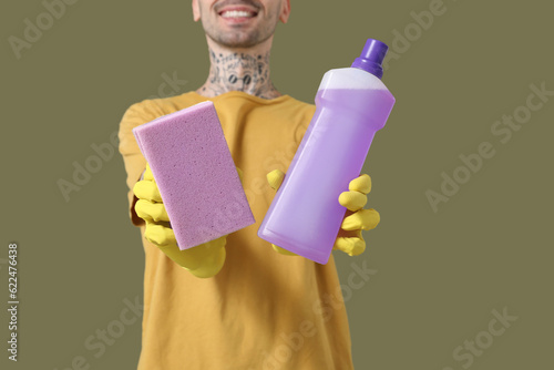 Smiling man in yellow glove...