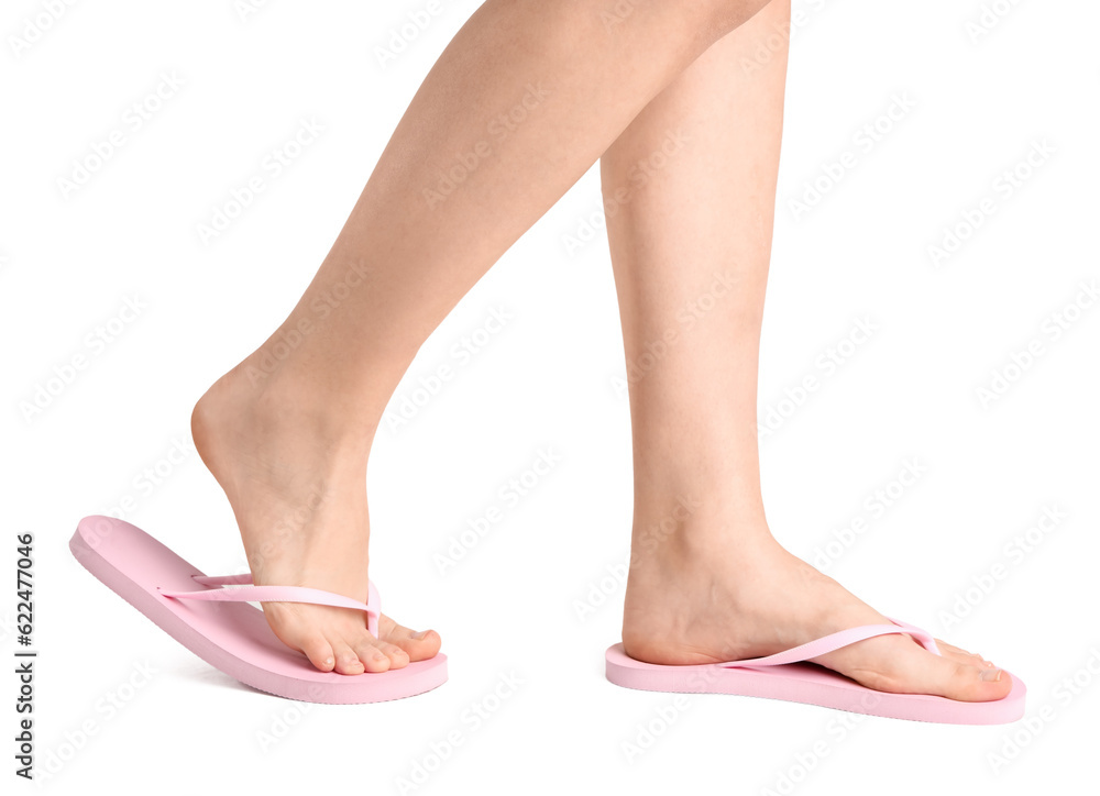 Female legs in flip-flops on white background Female legs in flip-flops on white background