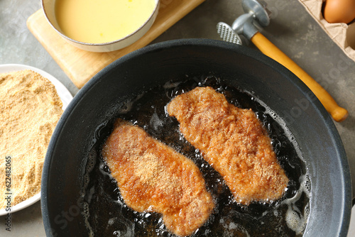 Photography Cooking schnitzels in frying pan, above view