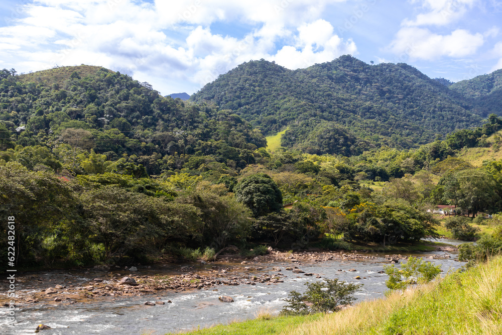 Beautiful natural landscape of river creek with mountains valley in the background - Mountain river water flow - Panoramic view of mountains with beautiful curved river, green forest, blue sky with cl Beautiful natural landscape of river creek with mountains valley in the background - Mountain river water flow - Panoramic view of mountains with beautiful curved river, green forest, blue sky with cl