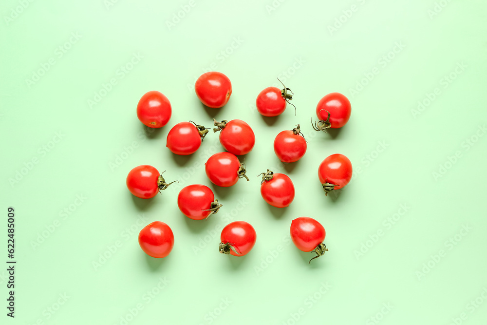 Many fresh cherry tomatoes on green background Many fresh cherry tomatoes on green background