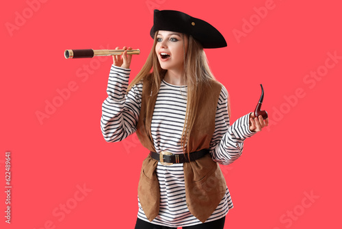 Canvastavla Beautiful female pirate with spyglass and smoking pipe on red background