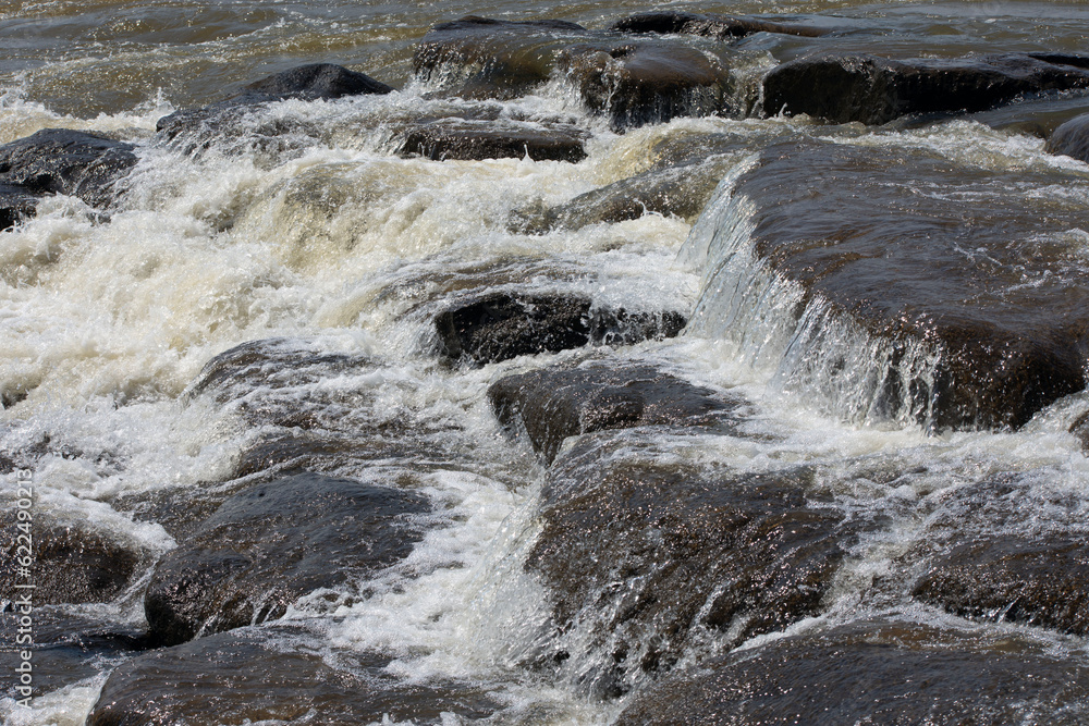 Water flowing over large rocks.
