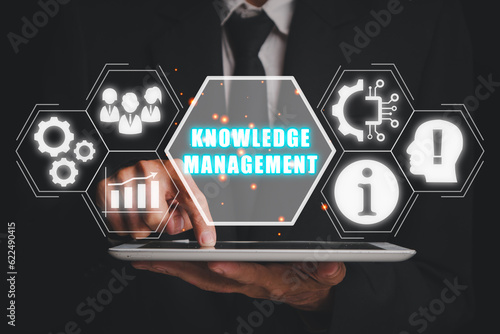 knowledge management concept, Businessman using digital tablet with knowledge management icon on virtual screen.