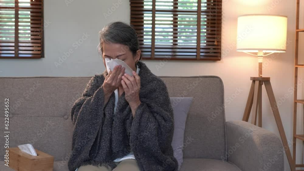 Sick asian senior woman holding breast having a bad cold Allergies and sore throat, Elderly health care concept. Sick asian senior woman holding breast having a bad cold Allergies and sore throat, Elderly health care concept.