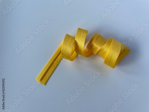 yellow colour bias tapes on white background 