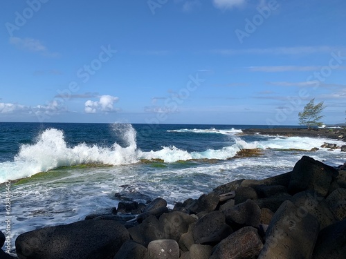 wave crashing onto rocky coast in Hawaii