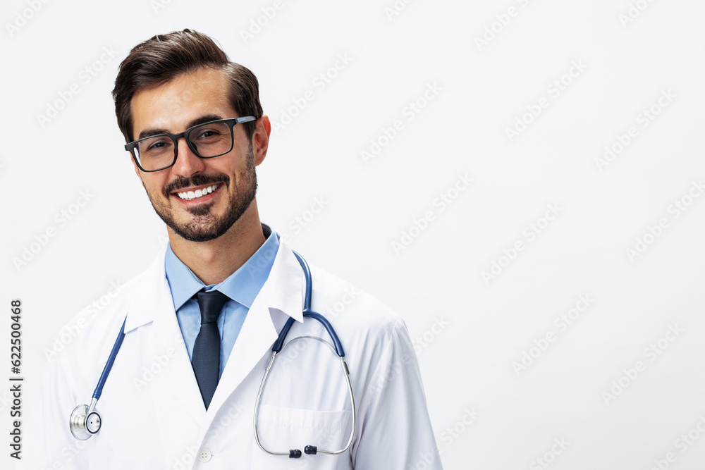 Male smile doctor in a white coat and eyeglasses and a stethoscope looks at the camera on a white isolated background, copy space, space for text, health Male smile doctor in a white coat and eyeglasses and a stethoscope looks at the camera on a white isolated background, copy space, space for text, health