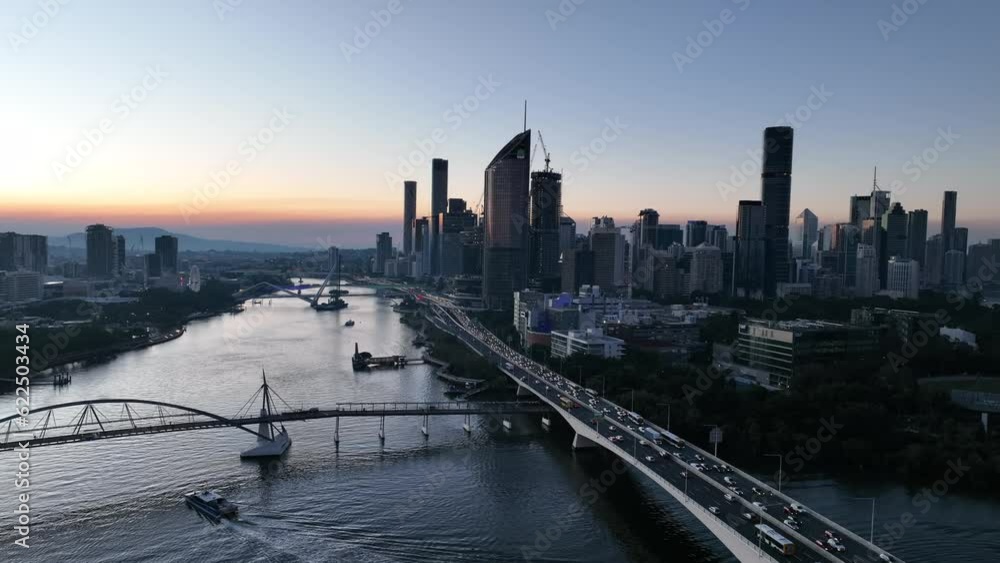 Static aerial shot of Brisbane City's Goodwill Bridge and Captain Cook Bridge Expressway Pacific Motorway. City Cat Boat boating across river. Flying above Brisbane River. Static aerial shot of Brisbane City's Goodwill Bridge and Captain Cook Bridge Expressway Pacific Motorway. City Cat Boat boating across river. Flying above Brisbane River.