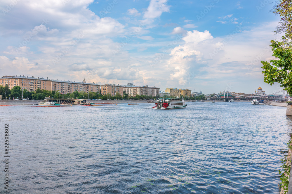 Obraz premium Cruise ship sails on the Moscow river in Moscow city center, popular place for walking.