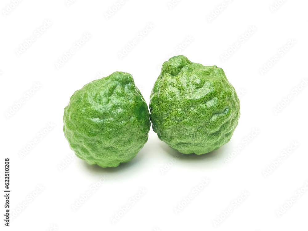 Fototapeta premium Fresh organic kaffir lime green The cut into pieces, rough skin, bergamot has many uses commonly used as a shampoo Or kaffir lime skin can be used as an ingredient in food put on a white background. 