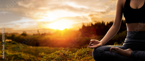 Young woman practicing yoga in sunset time