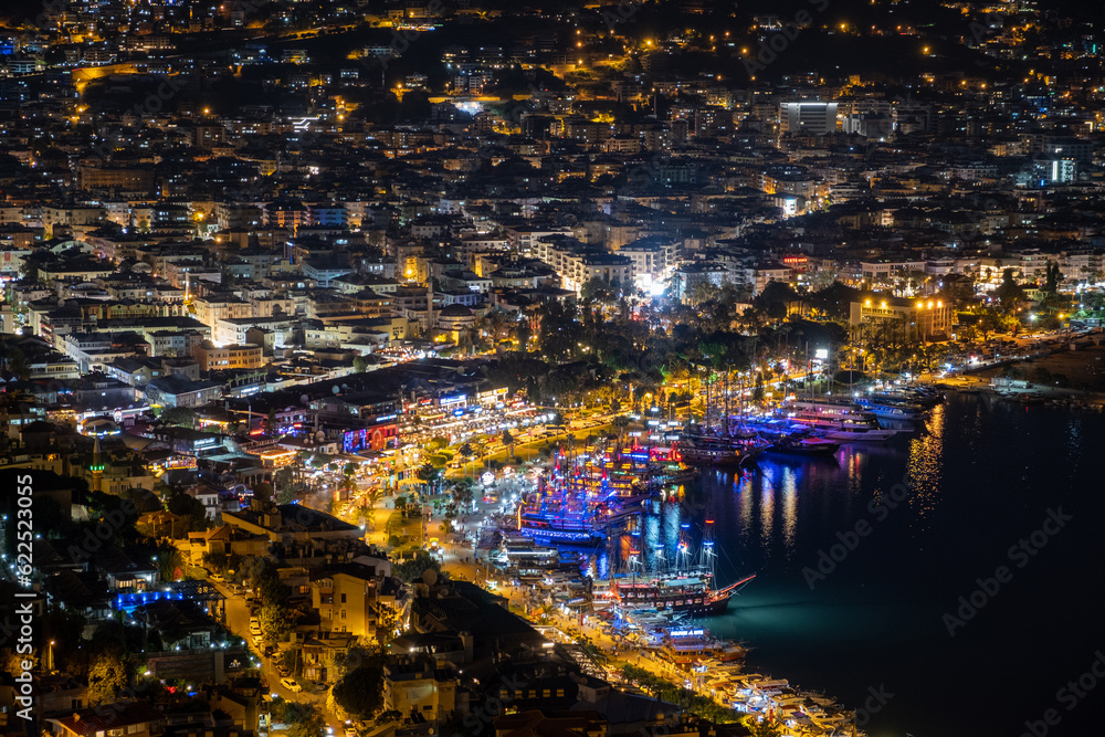 Night city. Alanya, Turkey. Beautiful lights of night city. View of Alanya harbor form Alanya peninsula. Turkish Riviera by night.