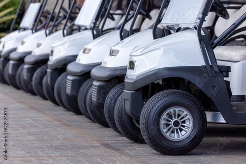 Fotografie Golf cars in a row outdoors on a golf course