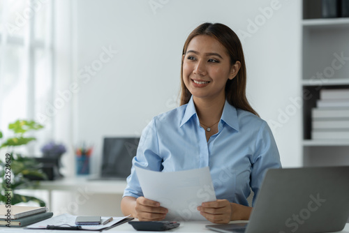 Businesswoman using a laptop computer with documents Calculator, notebook, on the table, planning, analyzing financial reports. business plan investment financial analysis concept