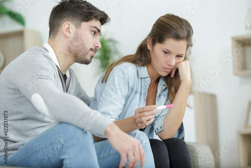 Fototapeta Naklejka Na Ścianę i Meble -  upset couple is looking at pregnancy test