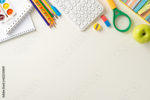 Embrace the convenience of distant learning with this top-down photo featuring a keyboard, notebooks and office supplies on white background. Ample copy-space available for text or ads