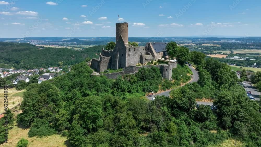Ruins of medieval Gleiberg castle in Hesse, Germany, located on the top of a volcanic mountain. Aerial 4K revealing video in summer Ruins of medieval Gleiberg castle in Hesse, Germany, located on the top of a volcanic mountain. Aerial 4K revealing video in summer