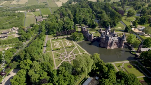 Aerial showing historic picturesque castle Ter Haar in surrounding Utrecht landscape with typical towers and fairy tale cants facade exterior on a bright day with landscaping gardens in the foreground photo