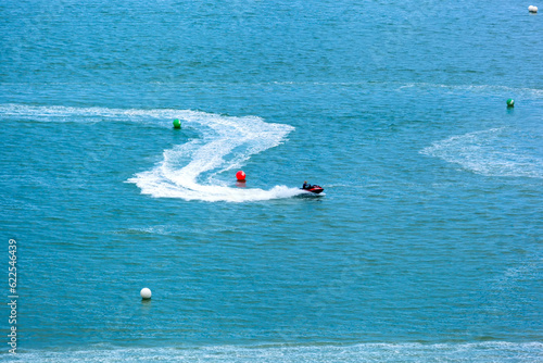 High angle view of jet skis cruising in deep blue sea photo