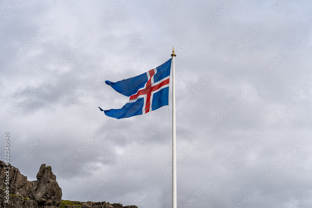 Icelandic flag waving against cloudy sky