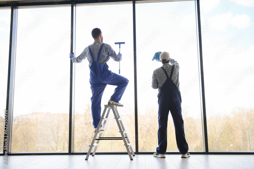 A man cleaning windows. cleaning team of men washes the windows