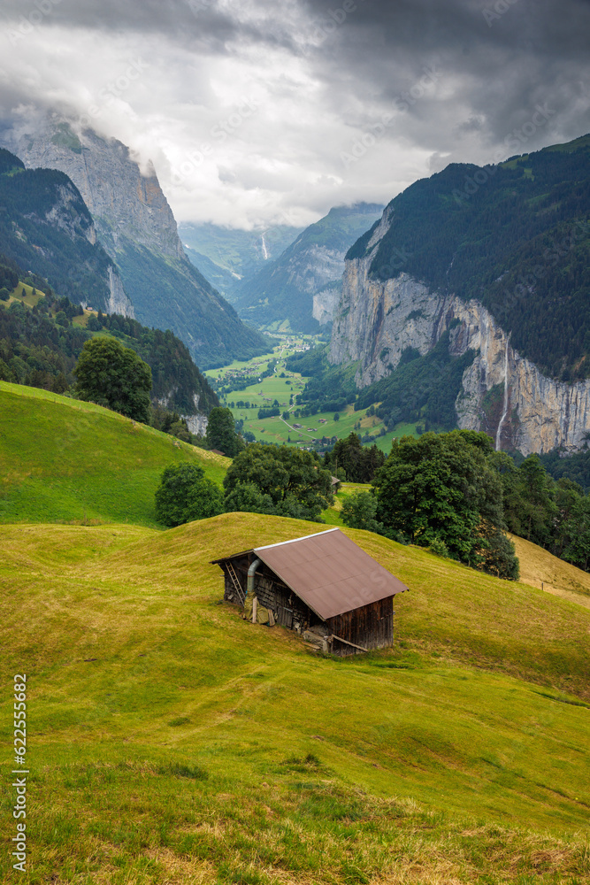 view from Wengen with farm shed through clouds into Lauterbrunnen valley