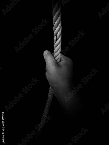 Man's hand holding on to the rope. On a white background