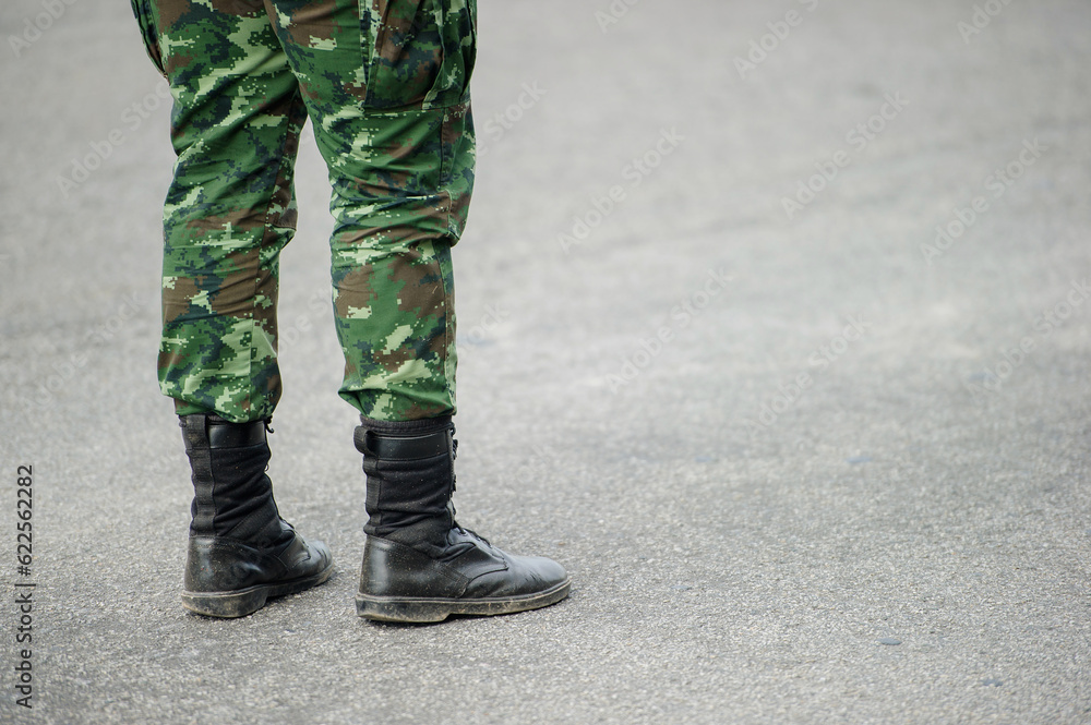 Uniformed soldiers stand with their backs turned. Uniformed soldiers stand with their backs turned.