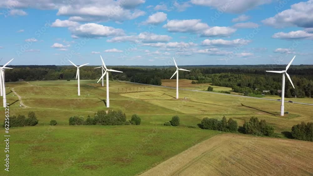 Aerial View of Wind Farm or Wind Park, With High Wind Turbines for Generation Electricity. Green Energy Concept. Energy Farm Wind Turbines in the Countryside. Beautiful Summer Day Day in Latvia 4K UHD Aerial View of Wind Farm or Wind Park, With High Wind Turbines for Generation Electricity. Green Energy Concept. Energy Farm Wind Turbines in the Countryside. Beautiful Summer Day Day in Latvia 4K UHD