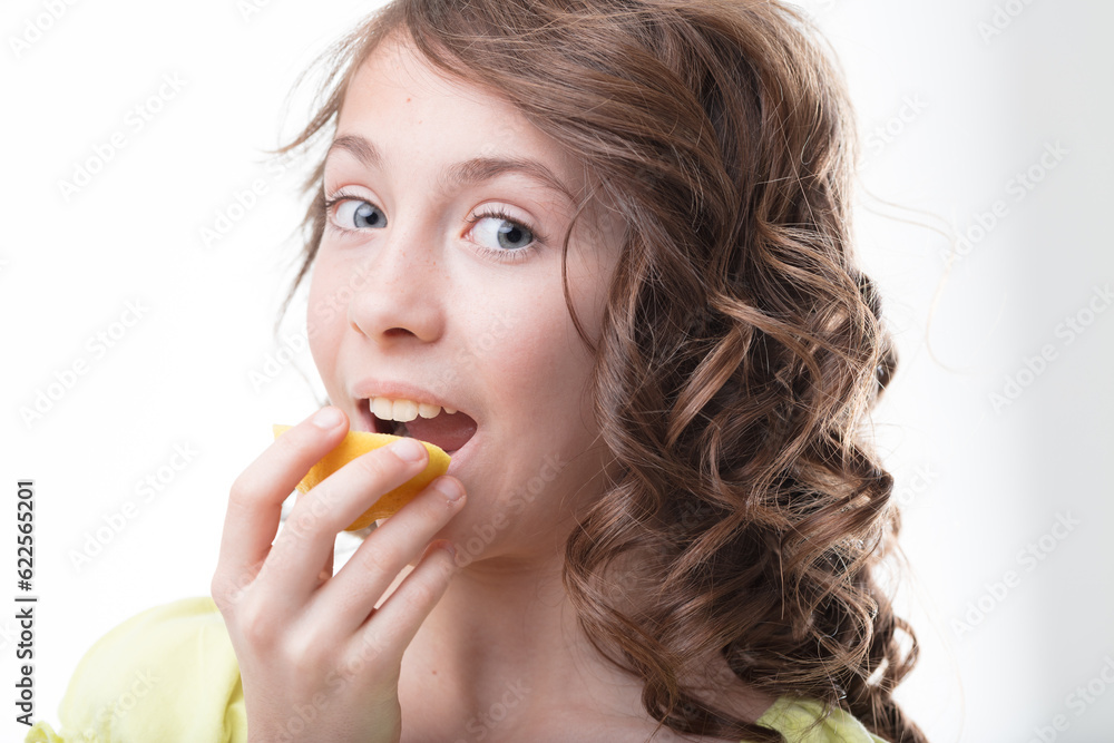 Girl with curls enjoys fresh lemon vitalit Girl with curls enjoys fresh lemon vitalit