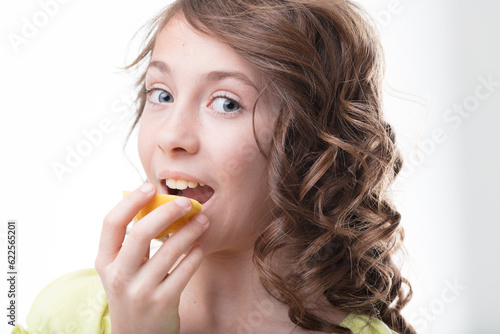 Girl with curls enjoys fresh lemon vitalit photo