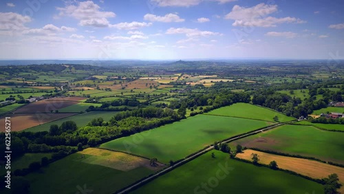 Somerset Levels with Glastonbury Tor in the centre of the frame. High speed aerial drone flight from Pilton photo