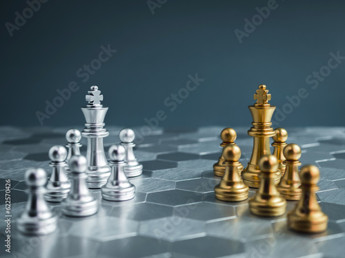Team of luxury golden and silver chess pieces with king and pawn standing on hexagon pattern floor background. Competition, game, war, partnership, versus, encounter, confront and planning concepts.