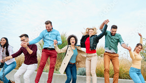 fun woman young man friendship group happy happiness jumping friend outdoor lifestyle together smiling female cheerful adult togetherness party girl jump