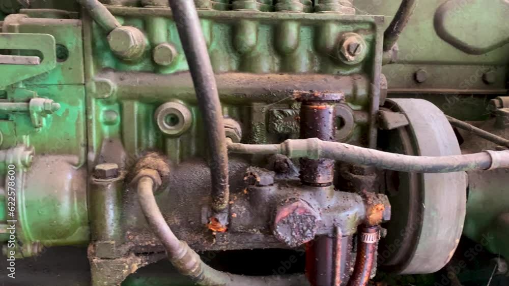 Sliding shot Detail shot of old emergency diesel generator with seeping oil. The pipes on the generator diesel engine. Oily diesel engine - Close up shot