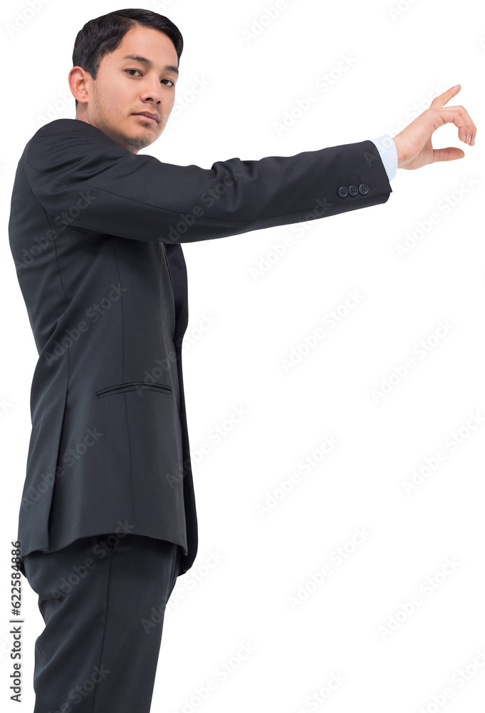 Digital png photo of serious asian businessman showing index finger on transparent background Digital png photo of serious asian businessman showing index finger on transparent background