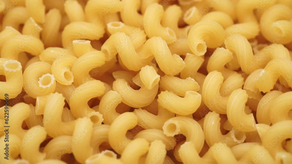 Background of Uncooked Noodles that Slowly Rotating. Texture of Dry Vermicelli Turning Around. Raw Pasta. Bunch of raw pasta spins in a circle Background of Uncooked Noodles that Slowly Rotating. Texture of Dry Vermicelli Turning Around. Raw Pasta. Bunch of raw pasta spins in a circle