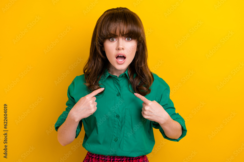 Photo of impressed shocked lady wear green shirt pointing fingers herself isolated yellow color background Photo of impressed shocked lady wear green shirt pointing fingers herself isolated yellow color background