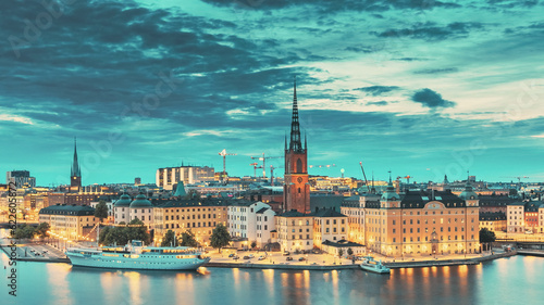 Stockholm, Sweden. Scenic View Of Stockholm Skyline At Summer Evening. Famous Popular Destination Scenic Place In Dusk Lights. Riddarholm Church Day To Night Transition © Grigory Bruev