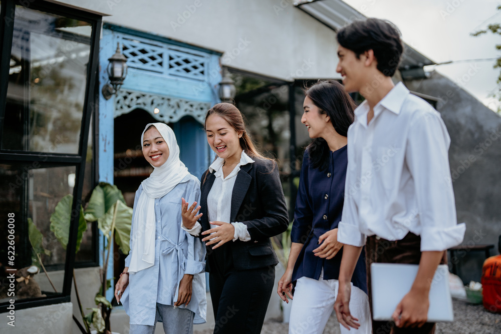 modern young people in casual clothes discussing business and chatting while walking in an outdoor workplace modern young people in casual clothes discussing business and chatting while walking in an outdoor workplace