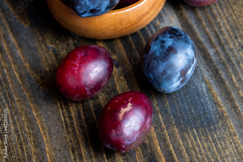 Ripe plums on the table in the kitchen