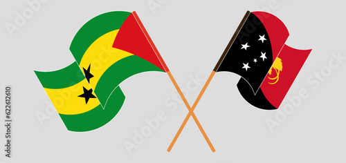 Crossed and waving flags of Sao Tome and Principe and Papua New Guinea