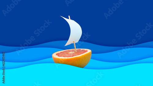 Boat made of grapefruit slice and paper sail against blue waves background. Original grapefruit decoration. Creative summer idea. Minimal style. Fruit concept.