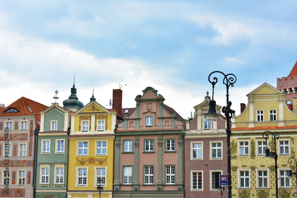 City view of the old buildings with colorful walls, decorative elements on the facades and lantern. Central square, old market with historical buildings. Old town. Poland, Poznan, July 2022.